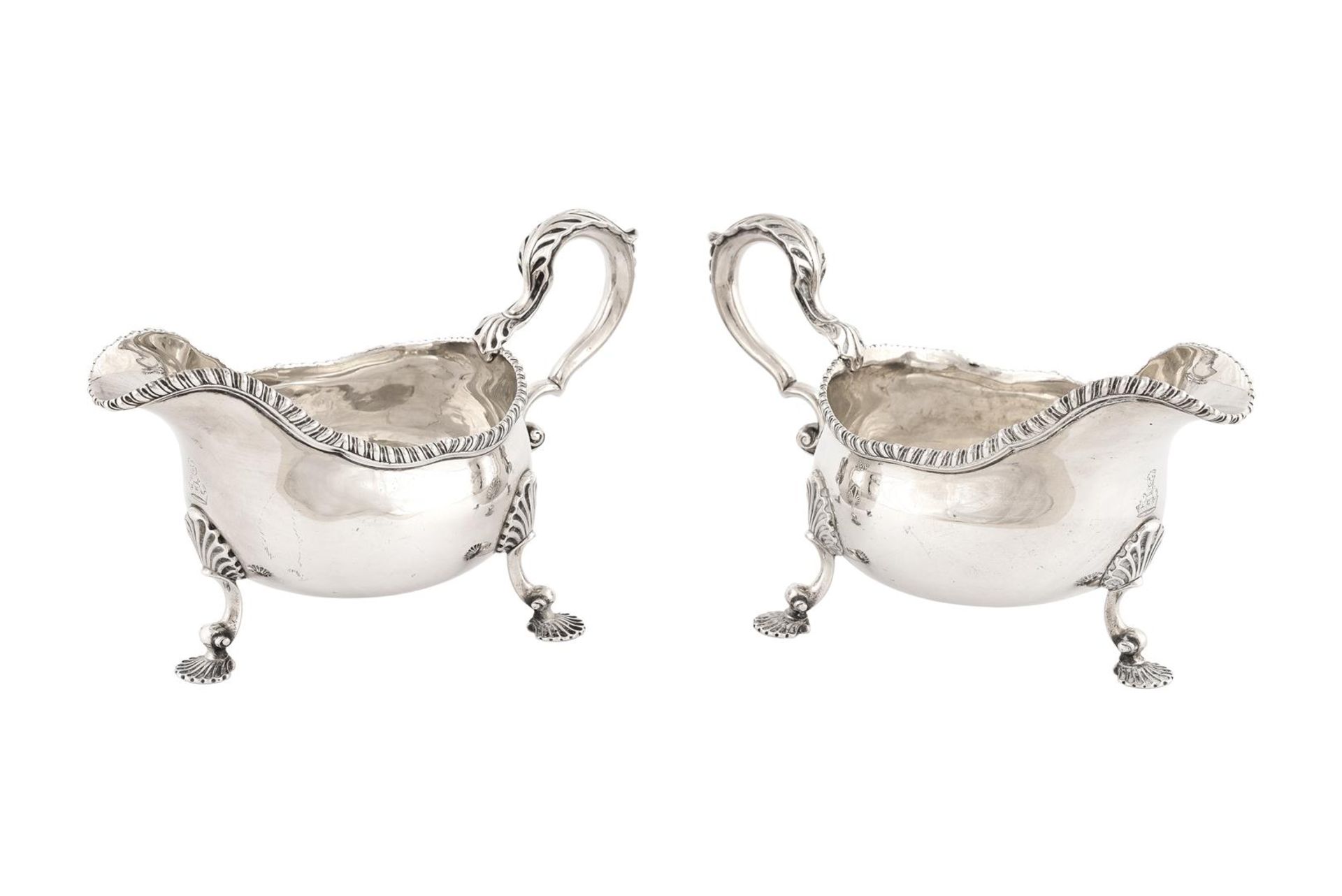 A pair of first grade silver sauce boats on three rocaille feet. London, 1765. Total weight approx.