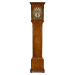 A burr on oak wooden tall case clock with an eight-day movement with day and date display. Edward