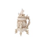 A carved ivory beaker with lid, decorated with putti. France, Dieppe, 19th century.