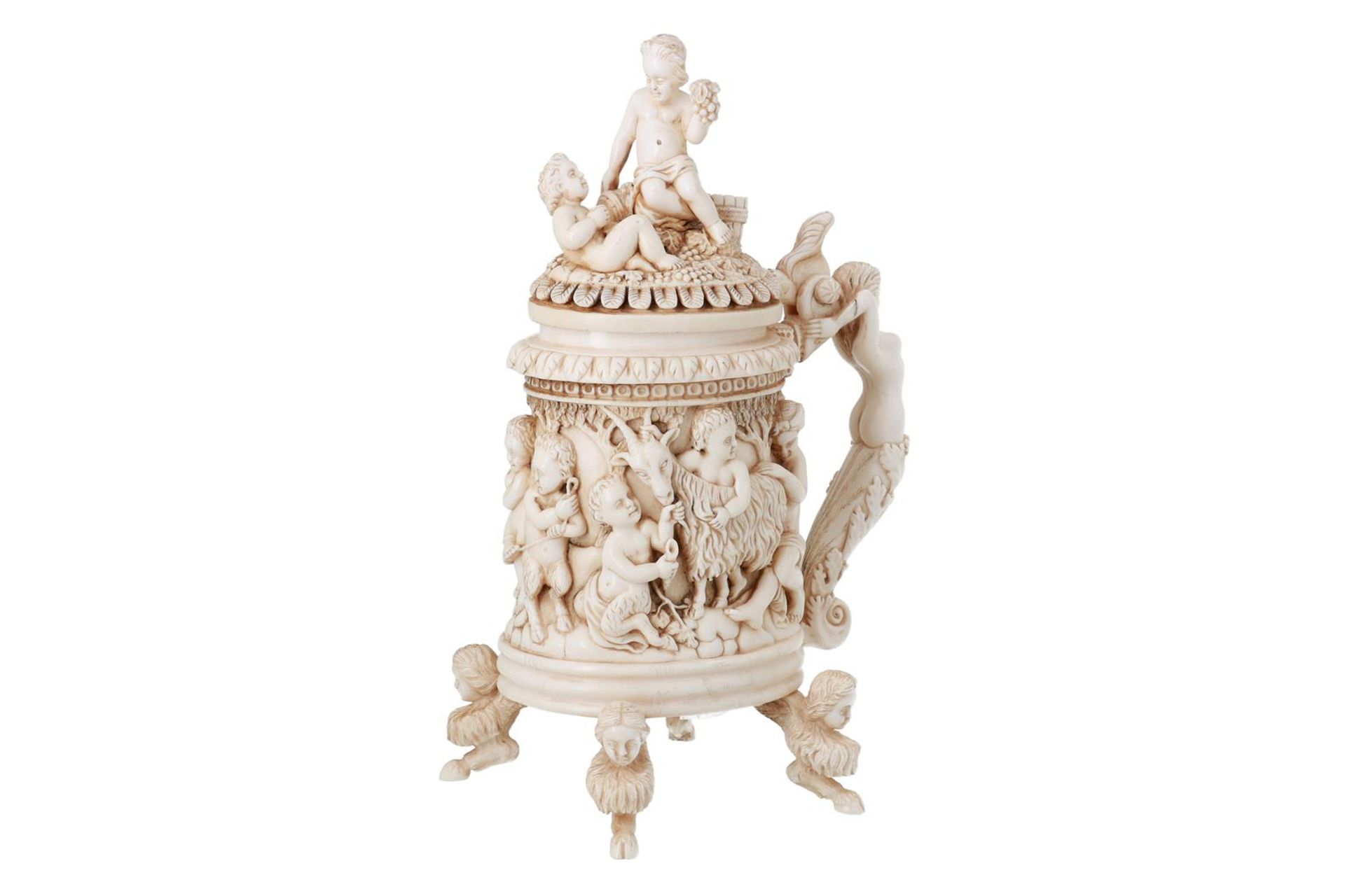 A carved ivory beaker with lid, decorated with putti. France, Dieppe, 19th century.