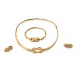 An infinity knot 18-kt golden choker with matching bracelet and a pair of ear clips. Total weight ap