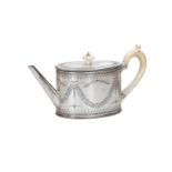An oval first grade silver teapot with ivory handle and knob. With engraving of garlands. England, 1