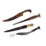 Lot of four diverse daggers, including Kadjar. The handles i.a. with ivory, gilding and jade. Three