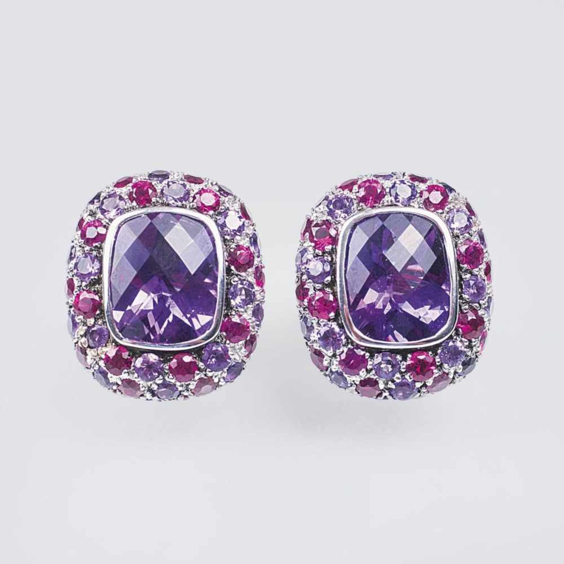A Pair of Ruby Amethyst Earstuds18 ct. white gold. In bezel setting two cushion shaped amethysts