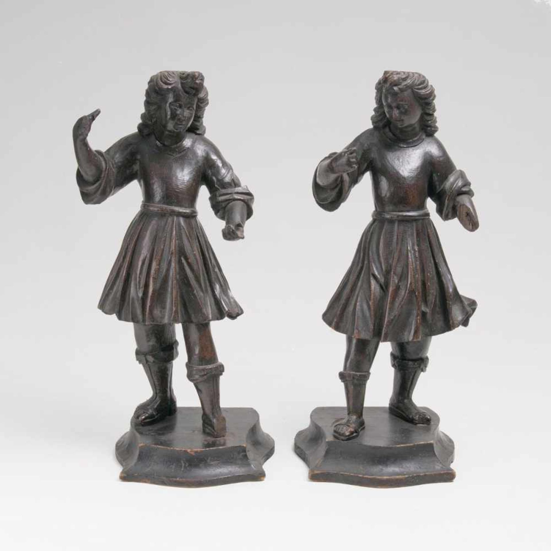 A Pair of AngelsTyrol, 17th cent. Dark stained coniferous wood, flat reverse. Wearing girded robes