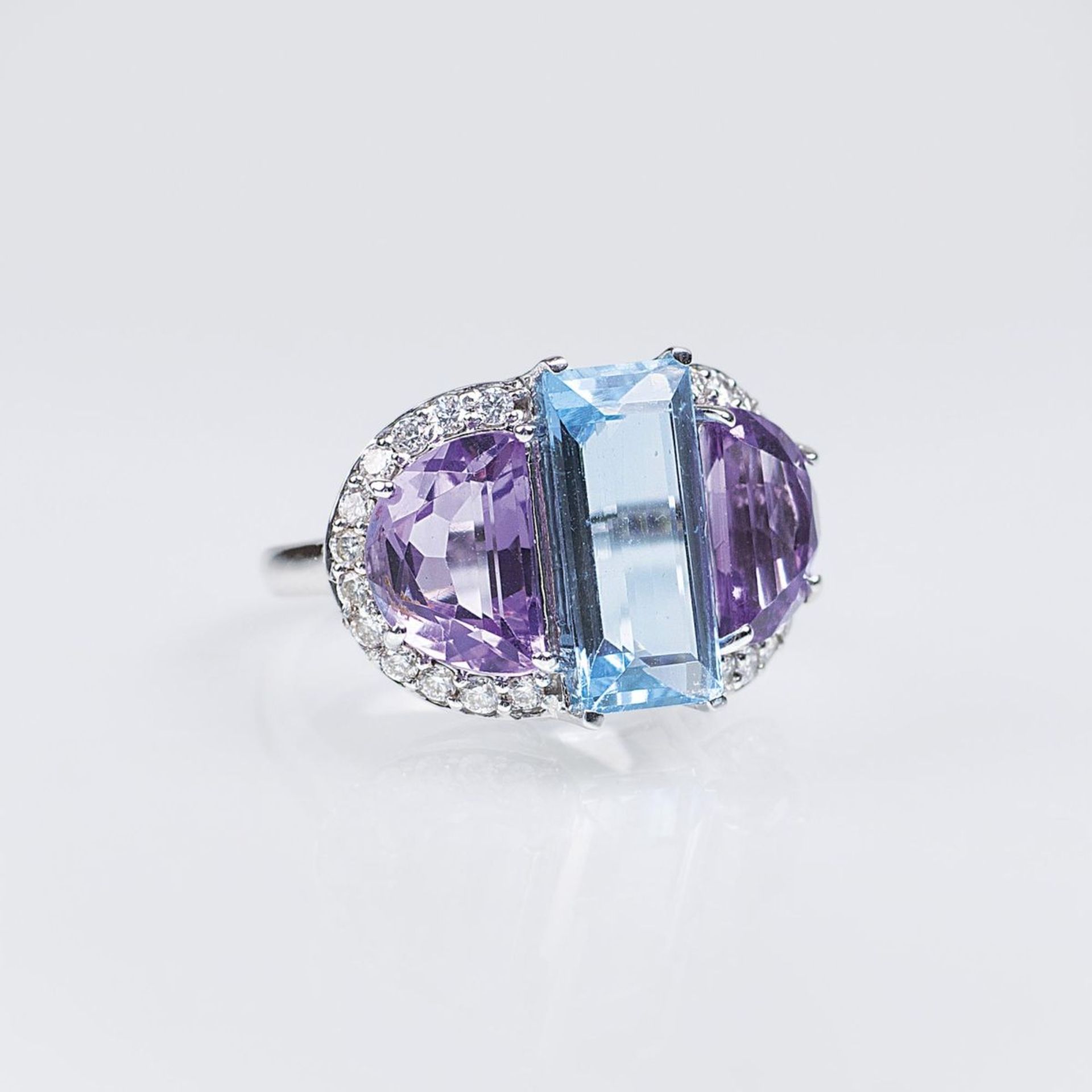 An Aquamarine Amethyst Ring14 ct. white gold. In front one aquamarine in step cut approx. 2,22