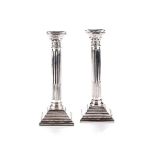 A PAIR OF SILVER CANDLESTICKS, BIRMINGHAM Modelled as Corinthian columns, each on a beaded stepped