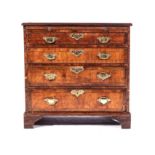 A GEORGE III WALNUT BACHELOR'S CHEST OF DRAWERS The rectangular quarter-veneered crossbanded top