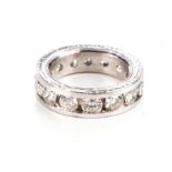 A DIAMOND ETERNITY RING Channel set with fourteen round brilliant-cut diamonds weighing