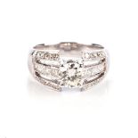 A DIAMOND RING Claw-set to the centre with a round brilliantcut diamond weighing approximately 0,