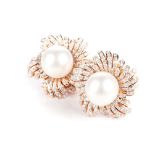 A PAIR OF SOUTH SEA PEARL AND DIAMOND EARRNGS Each designed as a stylised fower, centred with a