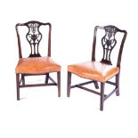 A PAIR OF CHIPPENDALE STYLE MAHOGANY SIDE CHAIRS, 19TH CENTURY Each curved toprail centred by carved
