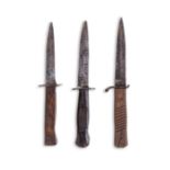 THREE WWI GERMAN TRENCH KNIVES Each with wooden handle (3)