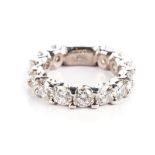 A DIAMOND ETERNITY RING Claw-set with thirteen round brilliant-cut diamonds weighing approximately