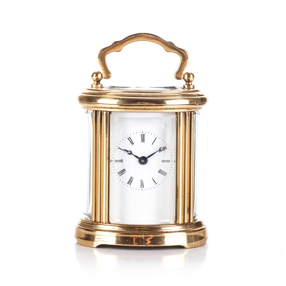 A BRASS CARRIAGE CLOCK The rectangular white dial with Roman numeral hour markers, calibrated