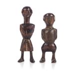 PAIR OF SHONA WOODEN DOLLS, ZIMBABWE The male and female couple in dark wood, one dressed in a skirt