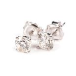 A PAIR OF DIAMOND EAR STUDS Each claw-set with a round brilliant-cut diamond weighing