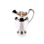 A SILVER JUG, TIFFANY AND CO The urn-shaped body with waisted neck and fared reeded lip, the side
