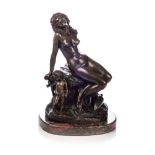 A FRENCH BRONZE STATUE OF A NUDE WOMAN, AFTER I. PRADIER Seated in relaxed pose on a hide thrown