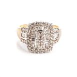 A DIAMOND CLUSTER RING The centred cushion-shaped plaque and shoulders claw and channel set with