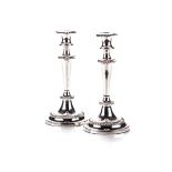A PAIR OF ELECTROPLATE CANDLESTICKS Each tapering stem beneath an urn-shaped sconce, detachable