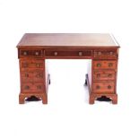 A GEORGE III MAHOGANY PEDESTAL DESK The moulded rectangular top with a gilt-tooled leather inset