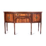 A GEORGE III MAHOGANY SIDEBOARD The bow fronted top above a central frieze drawer, a box drawer