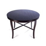 AN EBONISED TABLE, MANUFACTURED BY PIERRE CRONJE The circular top above a moulded frieze, on