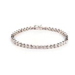 A DIAMOND TENNIS BRACELET Each circular link millegrain set with an old-cut diamond weighing