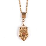 A LOCKET-PENDANT NECKLACE Composed of fancy-link chain, suspending a shaped locket engraved with