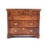 A GEORGE III WALNUT BACHELOR'S CHEST OF DRAWERS The hinged rectangular top above two short frieze