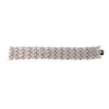 A DIAMOND BRACELET Designed as a broad fexible band composed of seven rows of regularly spaced