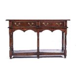 A GEORGE II OAK DRESSER The rectangular top above two short frieze drawers, beaded arched apron,