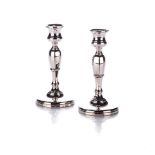A PAIR OF GEORGE V SILVER CANDLESTICKS, MAKER'S MARK RUBBED, BIRMINGHAM, 1928 Each with a faceted