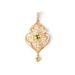 AN EDWARDIAN SEED PEARL AND PERIDOT PENDANT The openwork design composed of foliate scrolls