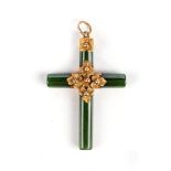 A GREEN STONE PENDANT, POSSIBLY SPINACH JADE In the form of a cross, embellished with foliate