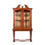 A DUTCH WALNUT DISPLAY CABINET, 19TH CENTURY The moulded broken pediment above a pair of glazed