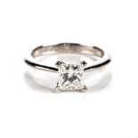 A DIAMOND SOLITAIRE RING Claw-set to the centre with a square modified brilliant-cut diamond