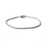 A DIAMOND TENNIS BRACELET Claw-set with 57 round, brilliant-cut diamonds, weighing 5,9cts, colour