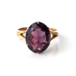 AN AMETHYST RING Claw-set to the centre with an oval, brilliant-cut amethyst, 1,8mm long, weighing