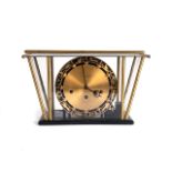 A BRASS AND STEEL CLOCK, MANUFACTURED BY ERNST JANNER The circular gold dial with ball hour markers,