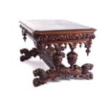A CONTINENTAL-STYLE OAK LIBRARY TABLE With lavish carvings to edge, frieze and pillars, baluster