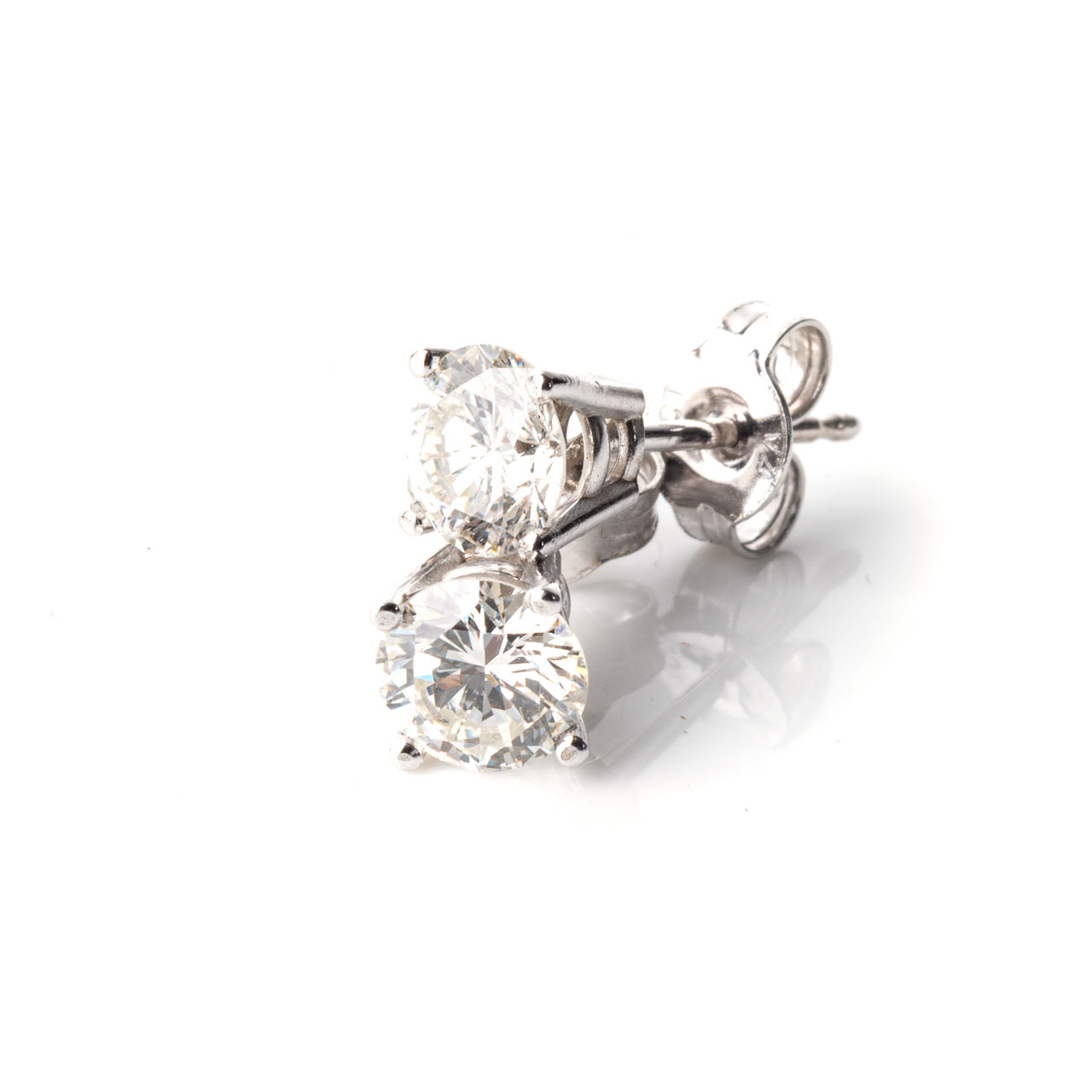 A PAIR OF DIAMOND STUDS Each claw-set to the centre with a round, brilliant-cut diamond, weighing