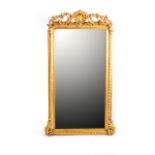 A FRENCH STYLE GILTWOOD MIRROR, 20TH CENTURY With crest and sides decorated with flower heads and