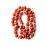 A CORAL AND GOLD NECKLACE Coral beads separated by 9ct gold beads with a hammered effect, 80cm in