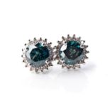 A PAIR OF DIAMOND EARRINGS Claw-set to the centre with a pair of natural green, enhanced diamonds,
