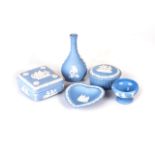 AN ASSORTED COLLECTION OF WEDGWOOD BLUE JASPERWARE Comprising: a 'Cherub on Branch' pattern bud