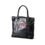 A GUCCI HANDBAG Leather black shopper with red, green and gold Gucci logo, two handles, secured by a