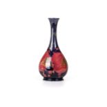 A MOORCROFT 'POMEGRANATE' PATTERN VASE Of gourd shape, maroon background, painted initials,