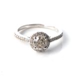 A DIAMOND HALO RING Claw-set to the centre with a round, brilliant-cut diamond, weighing 0,91cts,